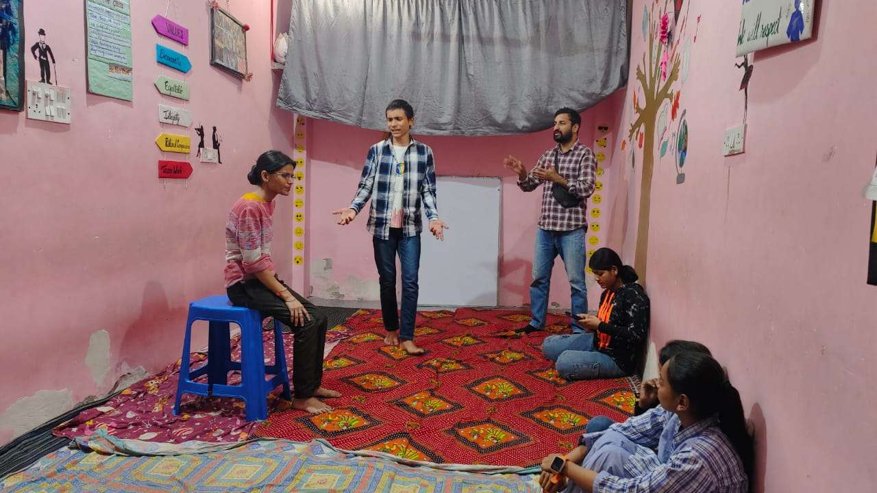 in a room a facilitator is conducting drama class.